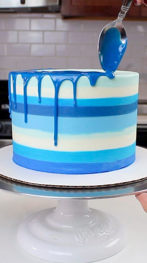 image of a blue colored drip being added to a striped blue cake Blue Drizzle Cake, Drip Cake Ideas For Men, Blue Icing Cake, Drip Cake Recipe, White Drip Cake, Hanukkah Cake, Blue Drip Cake, Buttercream Drip, Drip Cake Tutorial