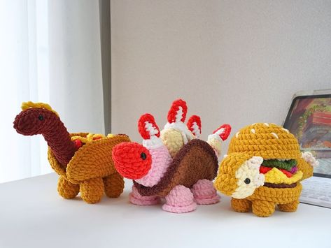 Free Crochet Patterns Everyday and Crafters on the Tedooo app! | ## Dino Snack Trio Crochet Pattern by Jeff Ratlis 🍔😋 | Facebook Funny Crochet Animals, Food Animals Crochet, Crochet Food Animals, Dino Crochet Pattern, Dino Crochet, Crochet Dino, Crochet Fish, Easy Crochet Animals, Crochet Stitches Guide