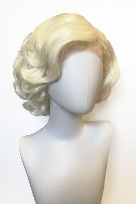 Blonde pinup style lace front wig Marilyn Monroe style with vintage waves Find out if blondes really have more fun... Marilyn's gorgeous curls and waves are the embodiment of the lady herself oozing old-school glamour and charm. We dare you not to be noticed in her! Made from the highest quality vegan fiber, which is so soft and silky, it feels like real hair. Details: WEIGHT: 120 grams LACE FRONT PIN UP WIG LENGTH: 13 inches / 33 cms LACE FRONT: Full lace front and lace part wig DENSITY: Full s Blonde Vintage Hairstyles, Blonde 50s Hair, Marilyn Monroe Haircut, Marilyn Monroe Wig, Blonde Short Wig, White Blonde Wig, Blonde Pinup, Blond Bombshell, Short Blonde Wig