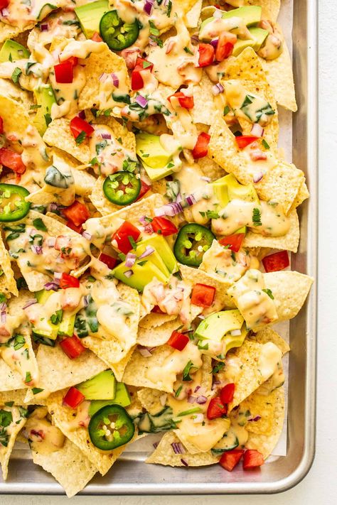 My go-to easy nachos recipe, made with my favorite Tex-Mex queso blanco dip, tortilla chips, avocado, tomato, red onion, jalapeño and cilantro. Feel free to add meat, beans, salsa, or any other toppings that sound good too! | gimmesomeoven.com Easy Nachos Recipe, Jalapeno Salsa Recipe, Queso Blanco Recipe, Kid Dinners, Nachos Cheese Recipe, How To Make Nachos, Latin Dishes, Nachos Ingredients, Nacho Toppings