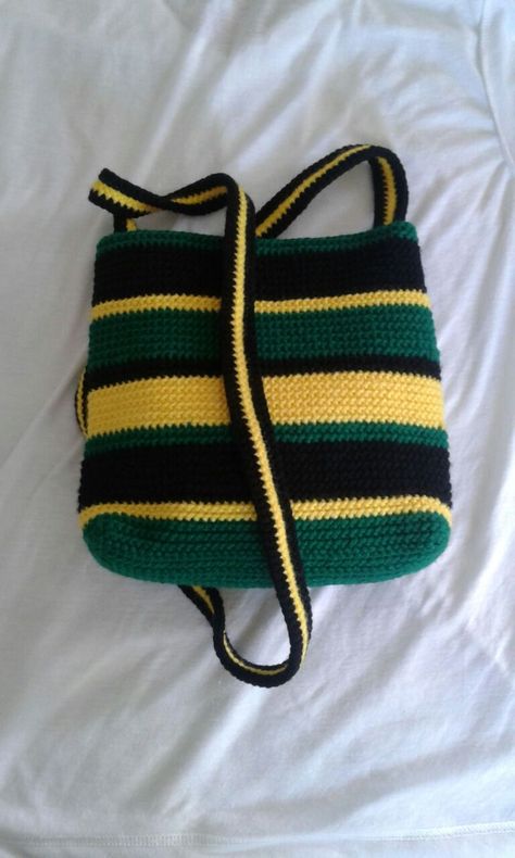 Jamaican Colored Crochet Bag. L: approx 8'', W:approx 3'', H:approx 7-8'', Strap: approx 50'' (non-adjustable) Interior lined, has an internal zipped pocket and a main outer zipper. Jamaican Crochet, Jamaican Clothing, Jamaican Colors, Flag Bag, Reggae Style, Crochet Fairy, Colorful Backpacks, Crochet Set, Crochet Stitches Tutorial