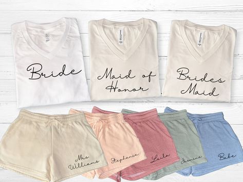 Personalized bridal party getting ready outfits for bride and bridesmaids. Perfect to wear on wedding day or bachelorette party.  Versatile set to use as pajamas, loungewear, or casual wear.  Mix and match shorts to match wedding theme. These sets make great bridesmaid gifts or proposal gift for bridal party.  Available in sizes XS to 2XL in dusty rose, blush, bone, sage, and misty blue shorts.  FREE STANDARD SHIPPING WITH ORDER OVER $35  ♥SHIRT AVAILABLE IN WHITE AND IVORY V NECK ONLY TO BEST M Wedding Party Pajama Set, Matching Bridesmaids Getting Ready, Wedding Day Gifts For Bride, Bridesmaid Morning Outfit, Bridesmaid Party Ideas, Day Of Bridesmaid Gifts, Bridesmaid Gifts From Bride Day Of, Clothing Product Shots, Getting Ready Outfits For Bridesmaids