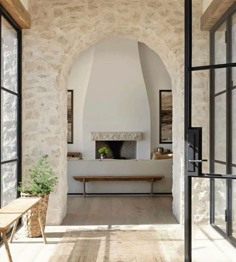 How to Decorate a Modern Mediterranean Home Intimate Living Interiors, Stone Tile Fireplace, Modern Spanish Home, Modern Mediterranean Home, Stone Entryway, Stone Archway, Tile Fireplace, Front Courtyard, Mediterranean Home Decor