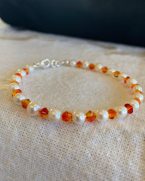 Freshwater pearl and crystal bracelet is great to wear everyday. Know an OSU fan? This would suit them well. Each crystal has shades of orange and even a shade of yellow here and there. It's finished off with a lobster clasp and four links to help make it adjustable. Orange Bead Bracelet Ideas, Fall Beaded Bracelets Diy, Orange Beaded Jewelry, Autumn Jewelry Diy, Orange Beads Bracelet, Orange Bracelet Ideas, Orange Beaded Bracelet, Autumn Bracelet Ideas, Orange Beaded Bracelets