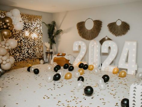 Chelsea and Cole dreamed up a color scheme, decorations and activities that would be a hit with everyone in their crew. They opted for sparkly metallics, chic black and white for their palette. (“Black and gold is always a good go-to for a New Year’s bash, or ANY party,” Chelsea says.) Then, they infused the space with plenty of holiday lights for a cheery glow. The pair gathered board games, constructed a glimmering photo booth and set up a family-favorite movie to keep their young guests entertained into the evening. Cole Deboer, Chelsea Houska, New Year Planning, New Year Photos, New Year's Eve Party, Favorite Movie, Eve Parties, New Years Eve Party, Set Up