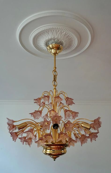 For Sale on 1stDibs - Elegant Italian brass and pink Murano glass chandelier. The light requires 12 single E14 screw fit lightbulbs (40 Watt max.) LED compatible. Measures: