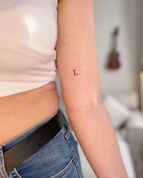 Typewriter Letter Tattoo, Typewriter Font Tattoo Initials, Letter Tattoo Placement Ideas, Child Initial Tattoo Ideas, Minimalist Initial Tattoo, Letter Arm Tattoo, Horse Minimalist Tattoo, Letter Fonts For Tattoos, L Tattoo Letter