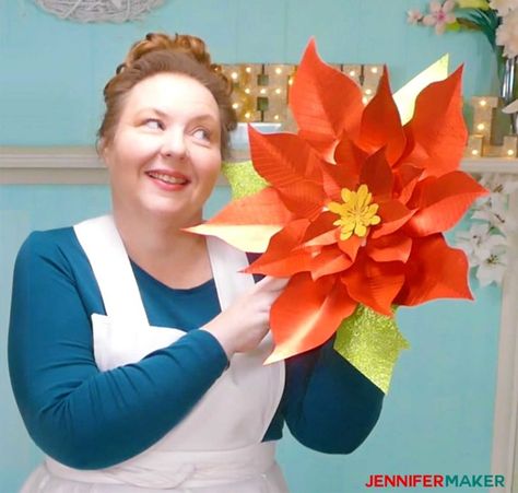 Jennifer admiring her giant paper poinsettia flower in her craft room Large Paper Flowers Diy, Paper Poinsettia, Christmas Day Celebration, Giant Paper Flowers Diy, Poinsettia Pattern, Jennifer Maker, Diy Christmas Candy, Make Paper Flowers, Halloween Table Runners