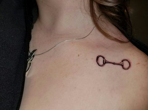 Snaffle bit tattoo under collar bone  Done by Anchors End Tattoo, Springville, NY Bit Tattoo Equestrian, Snaffle Bit Tattoo, Horse Bit Tattoo, Equestrian Tattoo, Bit Tattoo, Equine Tattoo, Small Horse Tattoo, Simple Tattoo With Meaning, End Tattoo