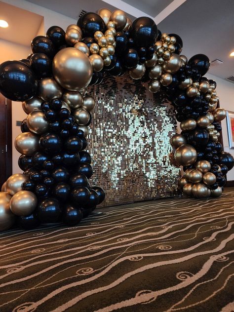 Gold backdrop, balloon arch, gold and black balloon arch, gold shimmer backdrop, party rental, and decoration Masquerade Ball Photo Backdrop, Black Golden Ballons Decoration, Black And Gold Balloons Background, Masquerade Party Balloon Decorations, Masquerade Ball Balloon Arch, Gatsby Balloon Arch, Black Prom Send Off Decorations, Black Balloon Arch Backdrop, Black And Gold Birthday Theme Decoration