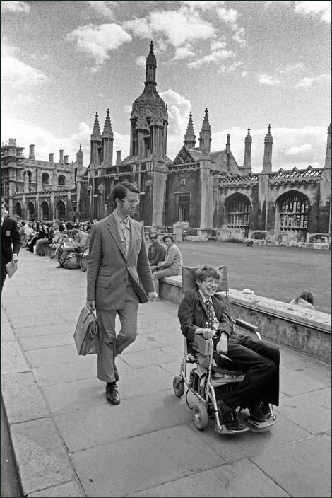 Ian Berry  England. Cambridge. Professor Stephen Hawking in his wheelchair in front of university buildings. 1977 Stephen Hawking Young, Stephan Hawkings, Steven Hawking, Professor Stephen Hawking, Ian Berry, The Theory Of Everything, True Believer, Prodigal Son, Physicists