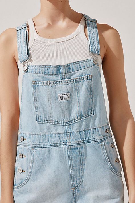 Retro staple Levi’s® shortalls in a classic, rigid denim. Designed in a relaxed fit with a front-bib pocket, adjustable straps and rolled cuffs. Features Levi’s® vintage shortalls Denim shortalls Bib front with pocket and adjustable straps Above-the-knee shorts Relaxed fit Mini length Adjustable straps 4-pocket styling Pull-on style with button closure Content + Care 100% Cotton Machine wash Imported Size + Fit Model in Light Blue is 5’9" and wearing size Small Measurements taken from size Mediu Above The Knee Shorts, Denim Shortalls, Denim Overalls Shorts, Classic American Style, Blue Fits, Denim Overalls, Overall Shorts, Slim Fit Jeans, Vintage Denim