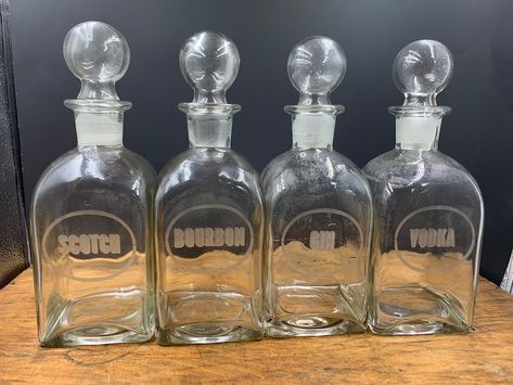 1950-1960 vintage decanter set with etched glass and glass stoppers. Boubon, Gin, Scotch and Vodka each 11” x 4” x 4” bar set dark academia Chemistry Glassware, Vintage Chemistry, Vintage Decanter Set, Vintage Decanter, Decanter Set, Decorating Style, Glassware Set, Etched Glass, Wedding Wishes