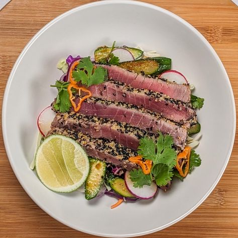 Sesame Seed-Crusted Ahi Tuna with Spicy Sesame-Soy Sauce Hey, seafood lover! Check out this salad, perfect for the summer with fresh flavors that make gourmet at home so easy. This delicious recipe combines classic flavors with a fresh twist. The dish is served on a vibrant bed of crunchy, shredded green and red cabbage, carrots, thinly sliced radish, and baby zucchini. It's boosted in flavor by a bold, spicy sesame-soy dressing with a kick of hot yuzu pepper sauce. Perfect for bringing rest... Ahi Tuna Recipe, Soy Dressing, Seared Ahi Tuna, Tuna Recipe, Seared Ahi, Pickled Cabbage, Ahi Tuna, Sesame Seed, Tuna Recipes