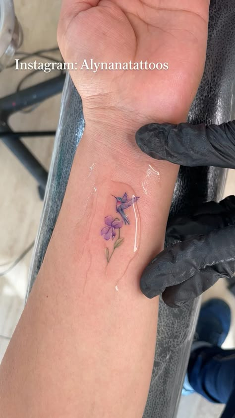 Hummingbird And Violet Tattoo, Small Remembrance Tattoos Hummingbird, Purple Bird Tattoo, Watercolor Neck Tattoo, Hummingbird Tattoo Finger, Hummingbird Iris Tattoo, Hummingbird And Lavender Tattoo, Pink Tatoos Ideas, Mother Daughter Tattoos Hummingbird