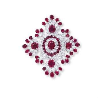 A RUBY AND DIAMOND BROOCH, BY VAN CLEEF & ARPELS The openwork lozenge shape panel of foliate design, centering upon an oval-shaped ruby, within a brilliant-cut diamond and circular-cut ruby two-tiered surround and marquise-cut diamond trim, extending to the oval-shaped ruby and marquise-cut diamond quatrefoil clusters, alternating with old European-cut diamond and circular-cut ruby accents, mounted in 18k white gold, 5.8 cm long, with French assay mark for gold Ruby Brooch, Van Cleef And Arpels Jewelry, Van Cleef And Arpels, Diamond Brooch, Royal Jewels, Marquise Cut Diamond, Ruby Jewelry, E Card, European Cut Diamonds