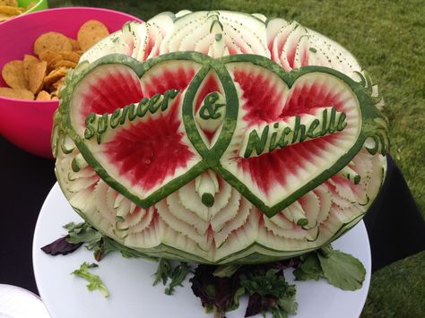 Bride & Grooms' names in a Watermelon Carving. Super festive! Valantain Day, Fruit Platter Ideas Wedding, Wedding Watermelon Carving, Watermelon Boat Carving, Watermelon Carving Wedding, Watermelon Elephant Carving How To, Heart Watermelon, Watermelon Bowls Carved, Fruits Carving