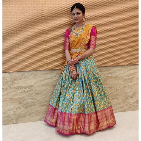 Festive vibes ~ classic yellow bhandini dupatta with combination of ikkat n kanchipuram border lehenga combines all tradition together… Pavadai Thavani, Pink Half Sarees, Half Saree Function, Ikkat Dresses, Lehenga Saree Design, Half Saree Lehenga, Indian Outfits Lehenga, Saree Blouse Neck Designs, Lehnga Dress