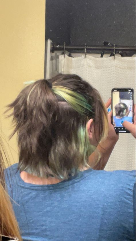 It is a picture of the back of someone’s head. She has short brown hair with green streaks. The hair is half up in a ponytail, it is textured and fluffy. Short Hair With Blue Streaks, Short Hair With Green Underneath, Bob With Green Highlights, Under Dyed Hair Green, Under Hair Dye Green, Green Highlights, Green Ombre, Cool Fits, Short Cuts