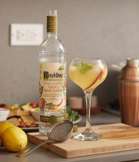 Ingredients:  1 1/2 oz. Ketel One Botanical Peach & Orange Blossom 3 oz. Fever Tree Soda Water 1 tsp. Raw Honey (Optional) 4-5 slices Peach 4-5 slices Lemon 1-2 sprigs Mint Preparation: Muddle peach and lemon slices in a cocktail shaker to combine. Add Ketel One Botanical Peach and Orange Blossom, honey (optional) and ice, shake well. Pour contents of shaker in a wine glass over fresh ice and top with club soda. Garnish with peach and lemon slices as well as a sprig of mint. Kettle One Vodka, Apricot Juice, Summer Vodka Cocktails, Peach Vodka, Peach Cocktail, Peach Drinks, Orange Vodka, Ketel One, Vodka Recipes