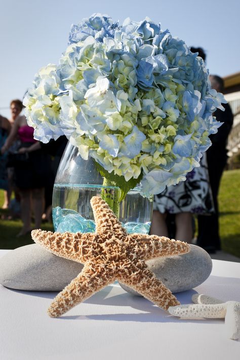 This flower arrangement was placed on the signing table. Under The Sea Flower Arrangements, Beach Theme Centerpieces, Beach Cottage Design, Beach Centerpieces, Beach Decorations, Vase Ideas, Under The Sea Theme, Baby Shower Flowers, Nautical Design