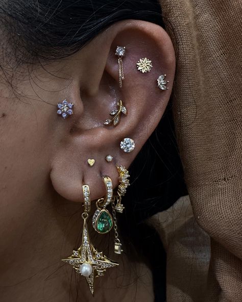 Adding more bling to this ear curation 🌟  Faux rook + stacks by @piercernomercy_  Soho, Union Square, and Williamsburg  11AM-9PM 7 DAYS A/W🕘 WALK-INZ OR BOOK ONLINE..📕 TATTOOS & PIERCINGS, NO ATTITUDE, NO MISERABLE HOOPS TO JUMP THROUGH....🚫  WALK-INZ WELCOME OR BOOK ONLINE AT  ⚔️livebytheswordtattoo.com⚔️ . . . . #fauxrook #stacks #earpiercing #earcuration #soho #manhattan Full Ear Pierced, Ear Piercings Curation, Cluttered Ear Piercings, Stacked Piercings Lobe, Stacked Ear Lobe Piercing, Piercing Stacks, Silver Ear Stack, Aesthetic Ear Piercings, October Jewelry