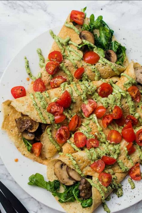 Savory Pesto Mushroom Crepe Recipe with pesto-goat cheese, wilted arugula, mushrooms, and tomato garnish. Wilted Arugula, Crepe Sale, Mushroom Crepes, Crepe Recipe Savory, Mushroom Crepe, Mushroom Filling, Crepe Recipe, Crepes And Waffles, Savory Crepes