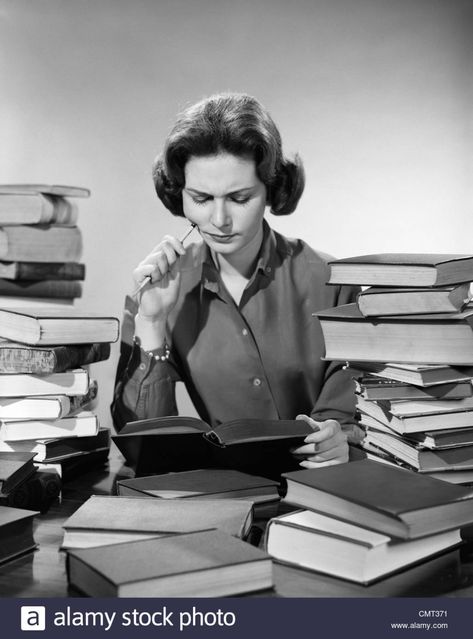 1950s 1960s COLLEGE WOMAN STUDYING SURROUNDED ALL AROUND BY PILES OF BOOKS Stock Photo Woman Studying, Narrative Story, Teacher Photo, Head In The Sand, Pile Of Books, Marcel Proust, Lose Your Mind, Student Debt, Woman Reading