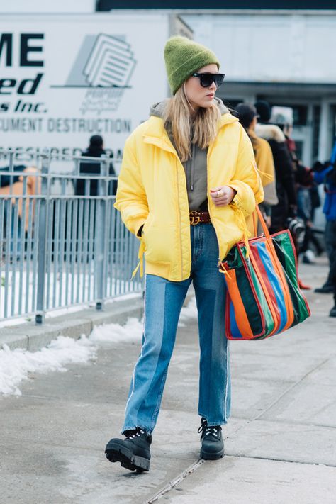 Marry a yellow puffer jacket with blue patchwork jeans for a refined yet off-duty ensemble. Make black leather lace-up flat boots your footwear choice for a more relaxed feel.   Shop this look on Lookastic: https://lookastic.com/women/looks/puffer-jacket-hoodie-jeans/24120   — Olive Beanie  — Grey Hoodie  — Yellow Puffer Jacket  — Multi colored Leather Tote Bag  — Brown Leather Belt  — Blue Patchwork Jeans  — Black Leather Lace-up Flat Boots Patchwork Jeans Black, Yellow Puffer Jacket Outfit, Yellow Jacket Outfit, Street Style Women Fall, Casual Chic Denim, Yellow Puffer Jacket, Street Style New York, Italian Fashion Street, Puffer Jacket Outfit