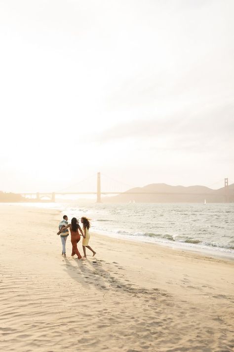 A son, mother and daughter hold hands while walking on the beach next to the Golden Gate Bridge Sunset Family Photos, San Francisco Beach, Beach San Francisco, San Francisco Photos, 2024 Ideas, California Sunset, Beach Family Photos, The Golden Gate Bridge, Beach Family