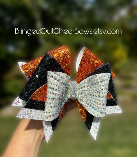 follow us on tiktok @blingedoutcheerbows to see brand new bow styles first! Price per bow is $25.  These bows are not discounted further for team orders  rhinestone cheer bow// orange Rhinestone cheer bow//competition cheer bow//bling bow//team colors//customizable bows// cheer bow leopard cheer bow❤️ Please allow 6 weeks for customization. like us on facebook "blinged out cheer bows" Bow Styles, Competition Cheer, Team Cheer, Bling Bows, Competitive Cheer, Cheer Bow, Cheer Bows, White Rhinestone, Black Orange