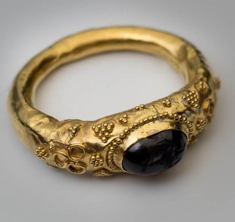 A museum quality ancient Roman gold ring, circa 1st century AD. This hollow gold ring (approximately 21K) is bezel-set with a garnet intaglio of Hippocamp - a fish-tailed horse that was considered the horse of Poseidon in Greco-Roman mythology. Poseidon was the god of the sea, earthquakes, and horses. The garnet intaglio measures 7.6 x 5 mm. The ring is elaborately decorated with applied gold wire and triangular-shaped beaded designs. Metal analysis report: 85.42% gold, 13.83% silver, 0.80% copp Ring Combo, Ancient Roman Jewelry, Ancient Jewels, Medieval Rings, Hollow Ring, Roman Jewelry, Ancient Jewellery, Greco Roman, Historical Jewellery