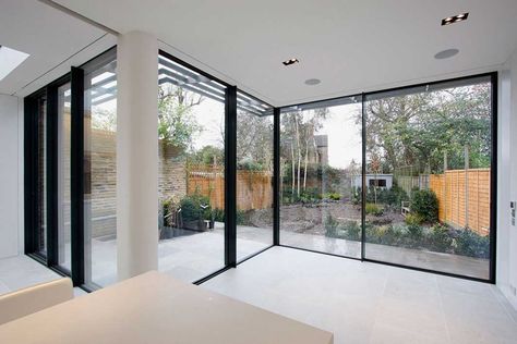 This rear kitchen dining, living extension in South West London benefits from IQ’s large sliding glass doors to the rea. The impressive floor to ceiling sliding glass doors are designed... Minimal Frame, Minimal Windows, Glass Extension, Corner Window, Sliding Door Systems, House Extension Design, Rear Extension, Extension Designs, Glass Roof