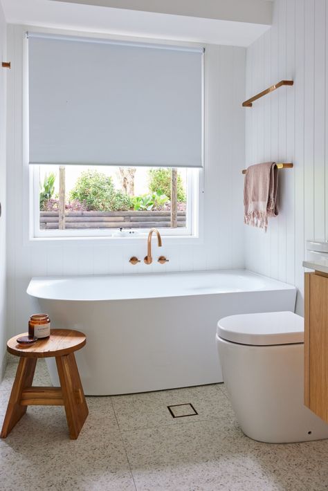 New bathroom & laundry layout elevates coastal home reno - The Interiors Addict Bathroom Laundry Layout, Panelled Walls Bathroom, Vj Panelling Bathroom, Elevated Coastal Homes, Copper Tapware, Laundry Layout, Vj Panelling, Danielle Victoria, Kitchen Island Bench