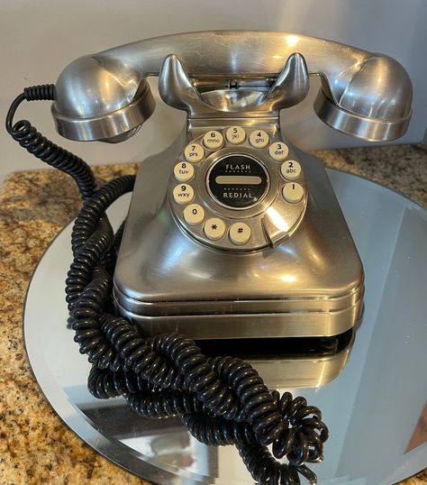 Here is a beauty for any desk!  Here is a desk phone " Grand".  Silver in color with white push buttons with black numbers and letter.  Almost like the Princess style! Flash redial in the center.  For a vintage look or collect memorabilia!  I do not know if it works.  I don't have a landline to test it.  Tag on the back says Class B digital apparatus complies with Canadian. Has an on off switch and volume control. Telephone Aesthetic, Free Mail Order Catalogs, Black Numbers, Rotary Phone, Vintage Phones, Retro Phone, Cigars And Whiskey, Vintage Telephone, Home Phone