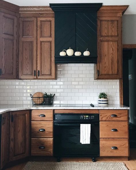 Eat-in kitchen - mid-sized traditional l-shaped light wood floor and brown floor eat-in kitchen idea in Columbus with an undermount sink, raised-panel cabinets, medium tone wood cabinets, quartz countertops, white backsplash, subway tile backsplash, black appliances and white countertops Hood Ideas, Modern Farmhouse Kitchen Decor, Kitchen Diy Makeover, Black Appliances, Brown Cabinets, Farmhouse Kitchen Cabinets, Wood Kitchen Cabinets, Custom Kitchen Cabinets, Modern Farmhouse Kitchens