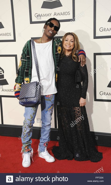 Google  A$AP Rocky did it again.  He wore this outfit to the 2016 Grammy's.  This messenger bag from Goyard had everyone talking.  His Gucci, and Goyard collaboration was a success.  What rapper can pull off a messenger bag at the Grammys?  A$SAP Rocky of course.  What's even cooler is that he paid tribute to his rapper friend A$AP Yams who had passed, bringing his mother as his date. Gucci Messenger Bag Outfit, Goyard Bag Outfit, Goyard Messenger Bag, Messenger Bag Outfit, Gucci Messenger Bags, The Grammys, Goyard Bag, Bag Outfit, Cool Outfits For Men