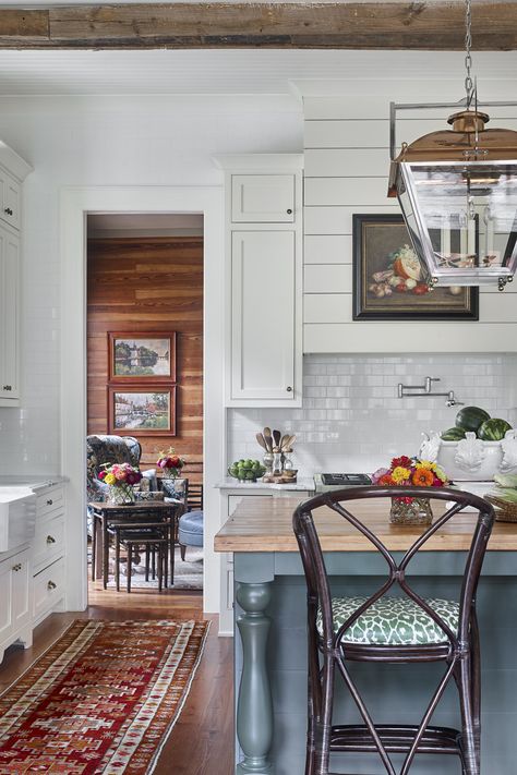 The shiplap-wrapped range hood ties together the home’s original and updated spaces. The subway tile backsplash, copper lantern, and furniturelike cabinetry imbue the contemporary kitchen, designed by James Farmer, with a classic feel. James Farmer Interiors, English Dining Room, James Farmer, Flower Magazine, Chippendale Chairs, White Molding, Up House, Breath Of Fresh Air, Historic Home