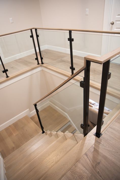 Stair, modern, home, glass railings, metal, posts, glass panels, staircase, design, style, farmhouse, Modern Stairs With Glass Railing, Metal And Glass Staircase, Floating Stairs With Glass Railing, Wood Glass Railings For Stairs, Interior Glass Railing Ideas, Stairway Hallway Decor, Black Metal Interior Stair Railing, Black And Glass Staircase, Indoor Glass Railings