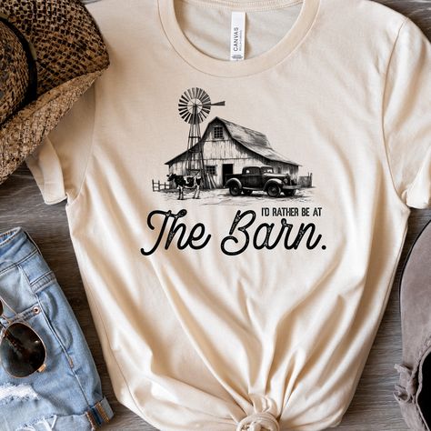 I'd Rather Be In  The Barn Shirt - Farm Shirt - Cow Shirt - Homesteader Shirt - Farm Girl - Farm Girl Shirt - Cow Lover Shirt - Country Girl Adult T-Shirts: Bella and Canvas 3001C and 3001CVD.  100% airlume and ring spun cotton.  Heathers are 52% airlume combed and ring spun cotton 48% polyester. Side seamed, pre-shrunk.  Unisex sizing.  Tear away label.   Ladies Racerback Tanks: Bella and Canvas tanks.  100% airlume combed and ring spun cotton. Heather colors are 52% airlume combed and ring spun cotton 48% polyester.  Athletic Heather 90% airlume combed and ring spun cotton/10% polyester.  Relaxed fit and tear away label.  All design material is CPSIA compliant.  Please choose shirt size and the shirt color from the drop down menus. Let us know the design color you would like for the desi Farm Shirts, Cow Shirt, Farm Girl, Graphic Tees Women, Racerback Tank, Country Girls, Shirts For Girls, Heathers, Colorful Shirts