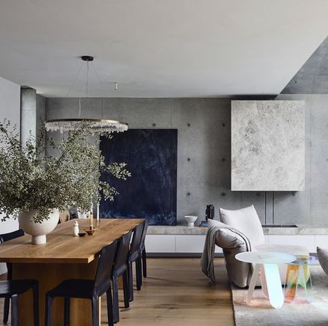 Contemporary living room with wood dining table, concrete wall, fireplace and wood floors #contemporarydesign #designinspiration #concretewall #concrete #diningarea #design #interiordesign #interiordesigner Concrete Interiors, Living Photo, Victorian Cottage, Concrete House, Architecture Awards, Australian Homes, The Design Files, Concrete Wall, Room Table