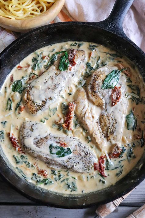 Indulge in campfire bliss with this Creamy Tuscan Chicken Skillet! Succulent chicken, spinach, sun-dried tomatoes, and creamy sauce, all cooked in a rustic cast iron skillet. Tuscan Skillet, Tuscan Chicken Skillet, Creamy Tuscan Chicken, Cast Iron Chicken, Creamy Chicken Recipes, Camping Lifestyle, Creamy Parmesan Sauce, Chicken Skillet Recipes, Chicken Skillet