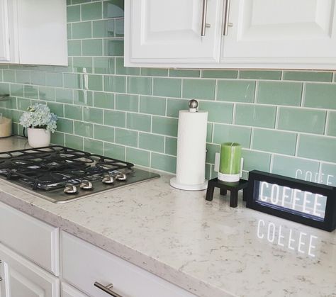 Subway tile in seaglass green backsplash with white grout, quartz countertop, white cabinets Green Kitchen Backsplash, Green Tile Backsplash, Green Subway Tile, White Grout, Green Backsplash, Cottage Kitchen Design, Subway Tile Kitchen, Brick Backsplash, Diy Backsplash