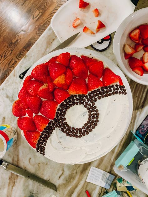 Easy and delicious pokemon pokeball cake with strawberries and mini chocolate chips, white frosting on a round two layer cake Pokemon Birthday Cake Easy, Easy Pokemon Cake, Diy Pokemon Cake, Birthday Cake Pokemon, Charizard Cake, Cake Diy Easy, Two Layer Cake, Cub Scout Cake, Pokeball Cake