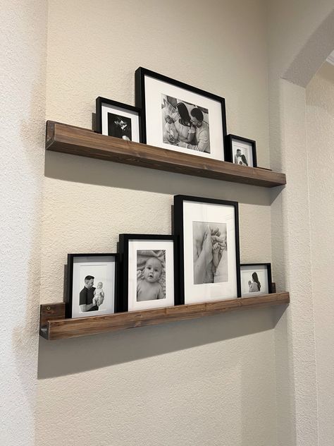 Black and white photos on floating shelf. Ikea picture frames Ikea Photo Shelf, Photo Shelf Decor, Picture Frames On Shelf, Ikea Picture Frames, Ikea Picture Frame, Shelf Ikea, Bathroom Picture Frames, Photo Shelf, White Floating Shelves