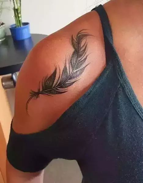 25 Beautiful Feather Tattoo Designs For 2023 | Fabbon Feather Tattoo On Thigh, Shoulder Feather Tattoos For Women, Feather Tattoos For Women On Shoulder, Feather Tattoo Thigh, Shoulder Feather Tattoo, Feathers And Flowers Tattoo, Feather Tattoo Shoulder, Feather Tattoo On Shoulder, Feather Memorial Tattoo