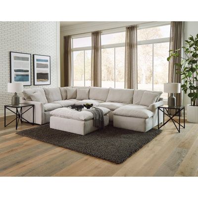 This ultra-modern convertible sofa and chaise set offers a cozy spot for you and your guests to unwind. The U-shaped design is crafted with a solid and engineered wood frame, and it's upholstered in polyester fabric in a versatile gray hue. The pillow-soft reversible seat tops feature individually pocketed coil springs integrated into the base, providing added support and comfort. This set comes with four toss pillows for a touch of extra relaxation. Plus, the padded ottoman is ideal for kicking