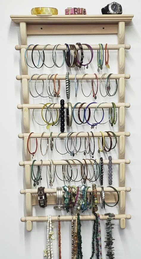 This Jewelry Storage Organizer is the perfect addition to any home looking for a stylish and functional way to organize their jewelry. With 7 bars for bracelets or bangles, this organizer has plenty of space to store your collection. The wall-mount design makes this organizer a space-saving solution, allowing you to easily store your jewelry without taking up valuable surface area in your bedroom or closet. Its sturdy wood construction also ensures that it will securely hold even heavier pieces of jewelry. This versatile organizer can be used for a variety of purposes, from holding bracelets and necklaces to displaying watches in an attractive way. And with its stable design, you can be sure that all of your precious pieces will stay securely in place. With easy wall-mount installation, th Bracelet Storage Ideas, Bangle Organizer, Bangle Storage, Bangle Holder, Jewelry Storage Wall, Organize Ideas, Jewelry Organizer Diy Wall, Headband Display, Dressing Room Closet