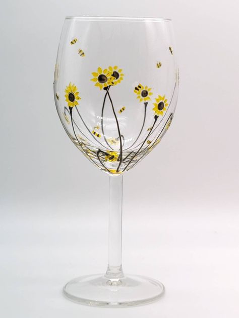 Hand painted small wine glass with 'Bee & Sunflower'  design.  Gorgeous translucent yellows  bring this glass to life.. perfect even if it's rainy outside.. sure to make the sun shine inside ! 😊.  Height : 18cm  Volume 33cl This is dishwasher safe so is usable, not just decorative.Although all of my designs are oven fired I would recommend that your glasses be hot hand washed to keep your glass in tip top condition. Rainy Outside, Diy Wine Glasses Painted, Bee Sunflower, Painting Glass Jars, Decorative Glass Jars, Glass Painting Patterns, Wine Glass Designs, Sorority Ideas, Diy Wine Glasses