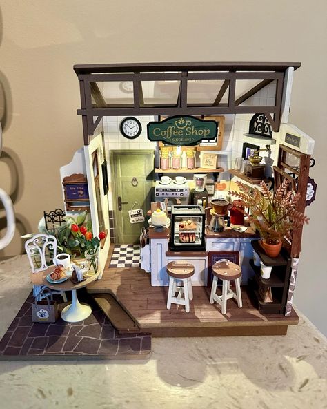 Isn’t this just the cutest? A miniature diy coffee shop! ☕️ Sits on our coffee bar. It even has a working light 💡 Robyn’s quite talented! 😃 Coffee Shop Miniature, Diy Coffee Shop, Miniature Diy, April 4, Diy Coffee, Coffee Bar, The Cutest, Coffee Shop, Miniatures